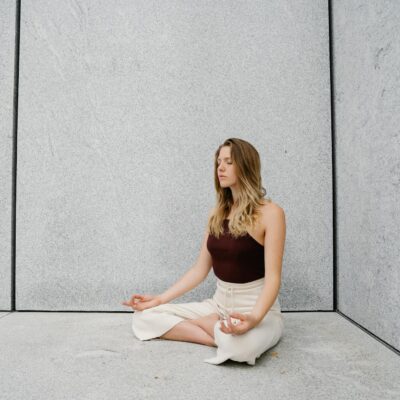 Young woman practicing yoga meditation indoors with calm expression and peaceful atmosphere.